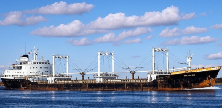 A ship sitting under a bright cloudy sky